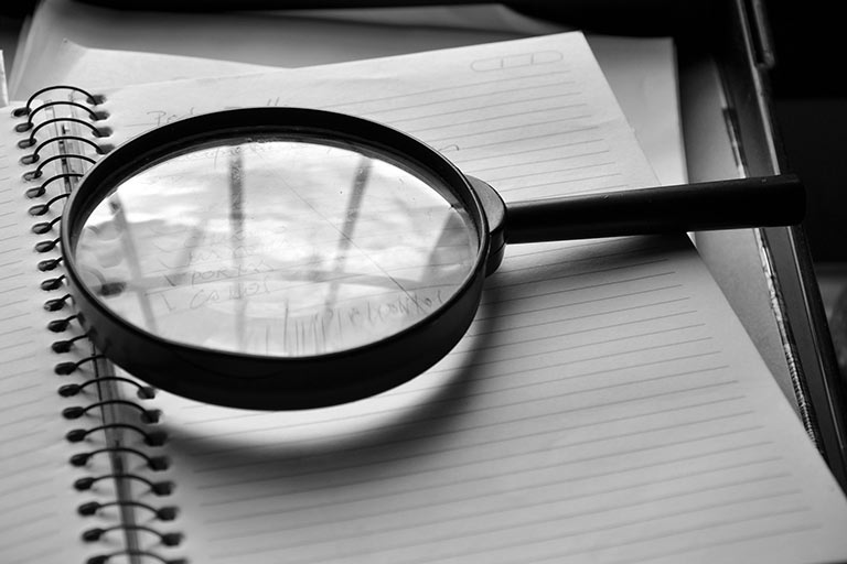 Magnifying glass on notepad
