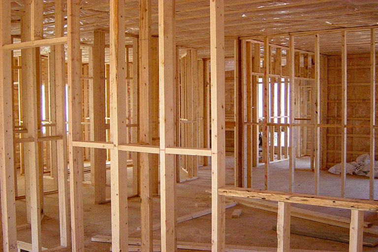 Timber stud walls being built in a large space