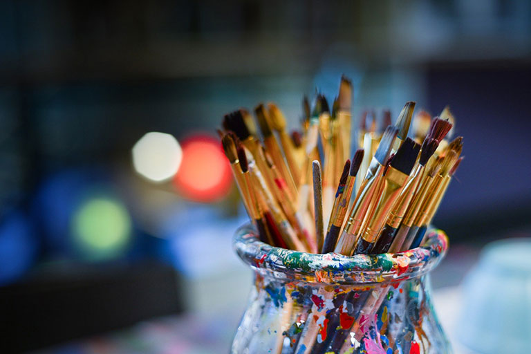 Paint brushes in a jar